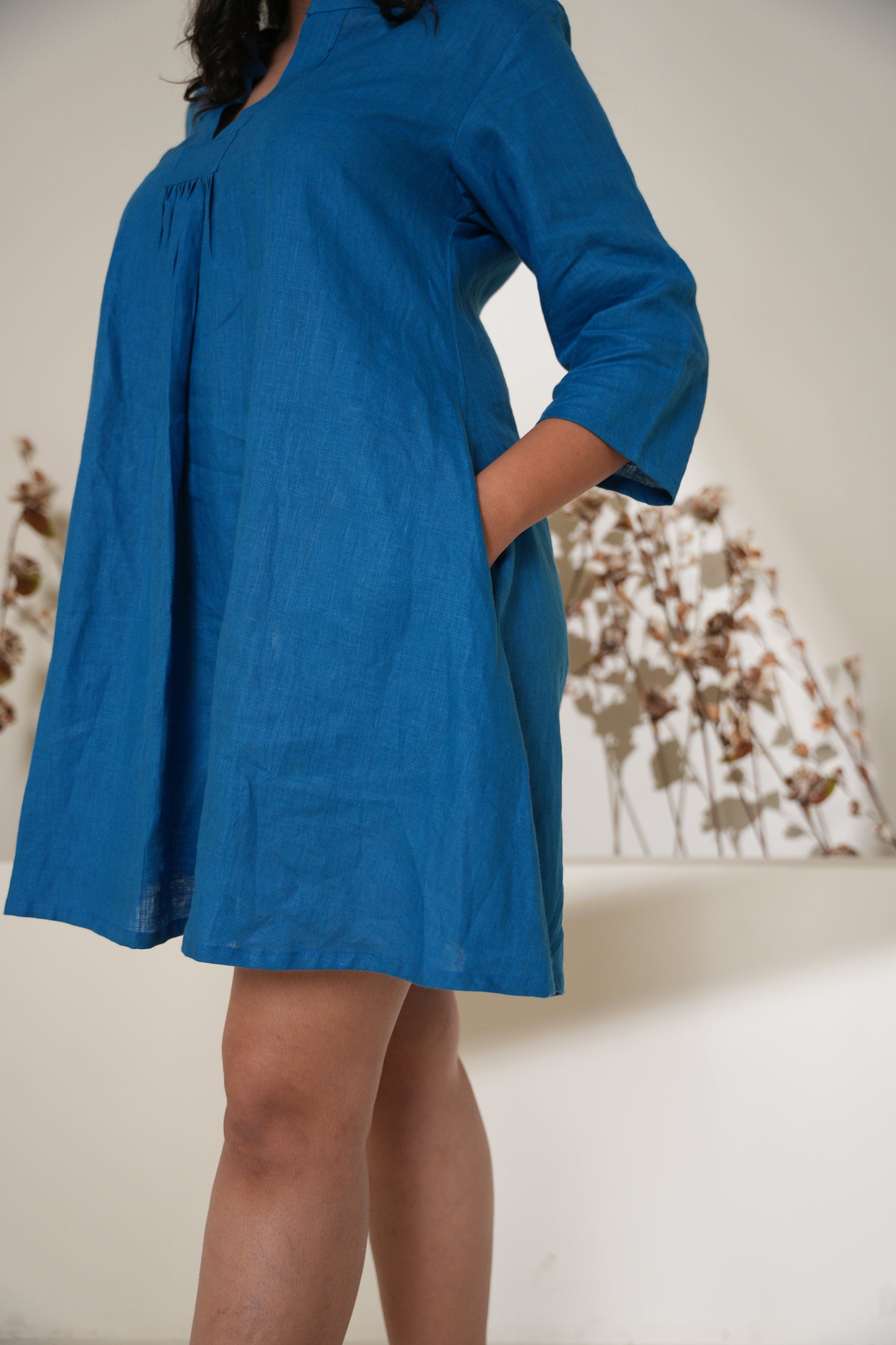Close-up of a collar short dress, showcasing a sleek, structured design and soft fabric.