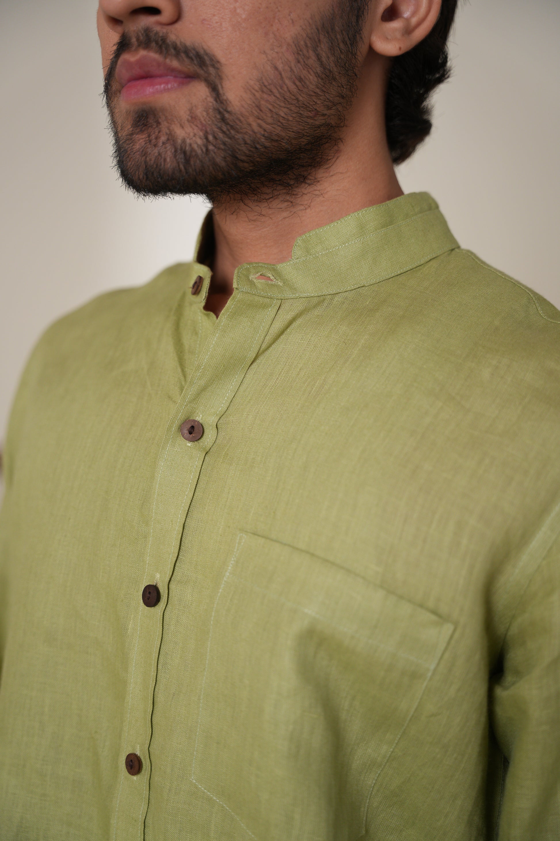 Casual sage green short kurta with a modern cut, ideal for pairing with jeans or trousers.