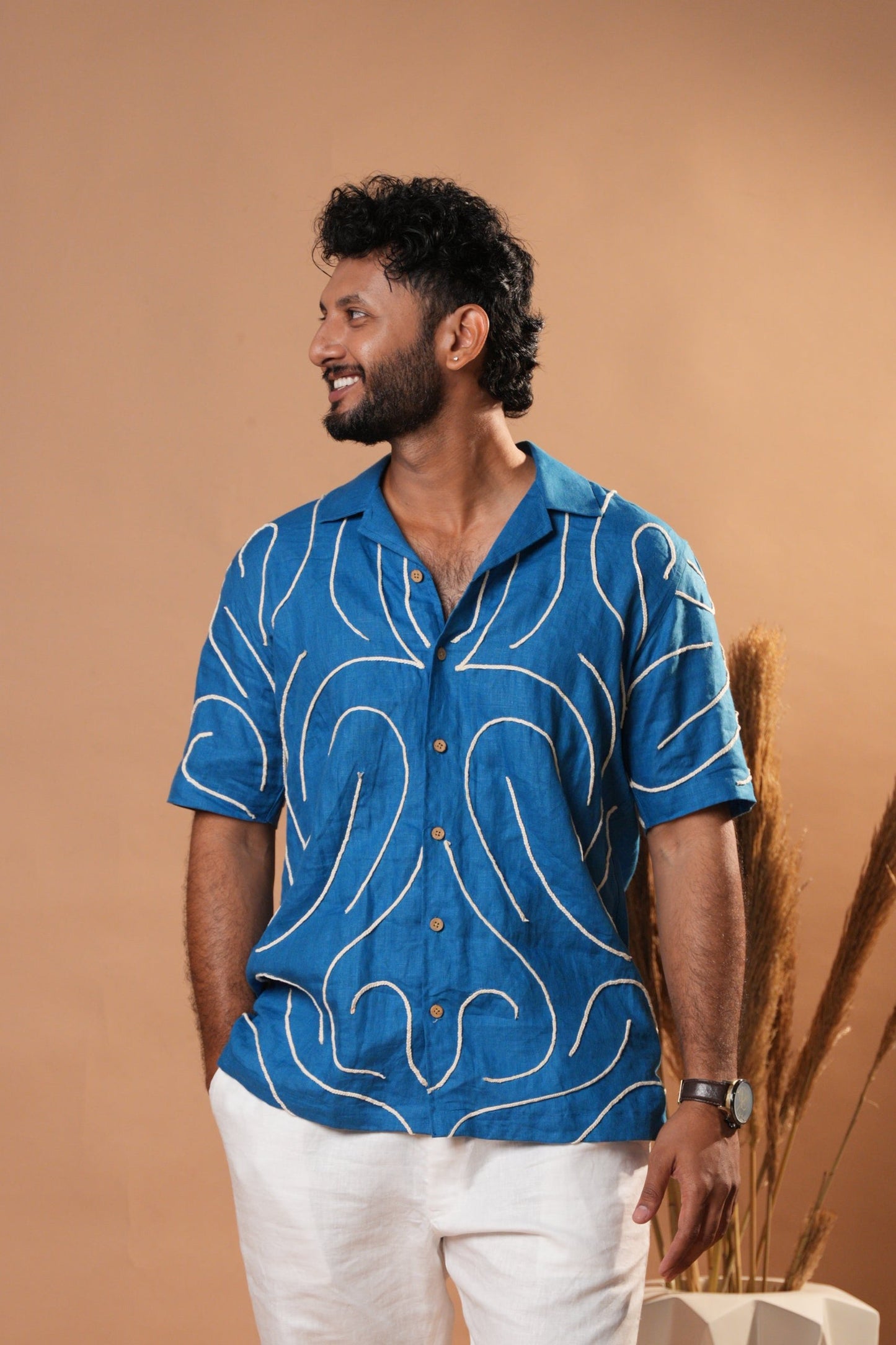 Casual embroidered shirt in deep blue, featuring intricate floral stitching on the front.