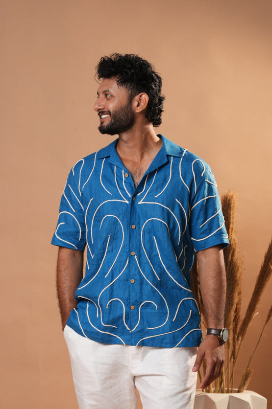 Casual embroidered shirt in deep blue, featuring intricate floral stitching on the front.