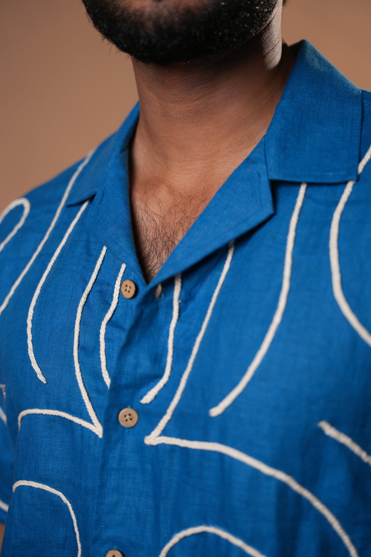 Stylish deep blue shirt with subtle embroidery, perfect for casual and semi-formal occasions.