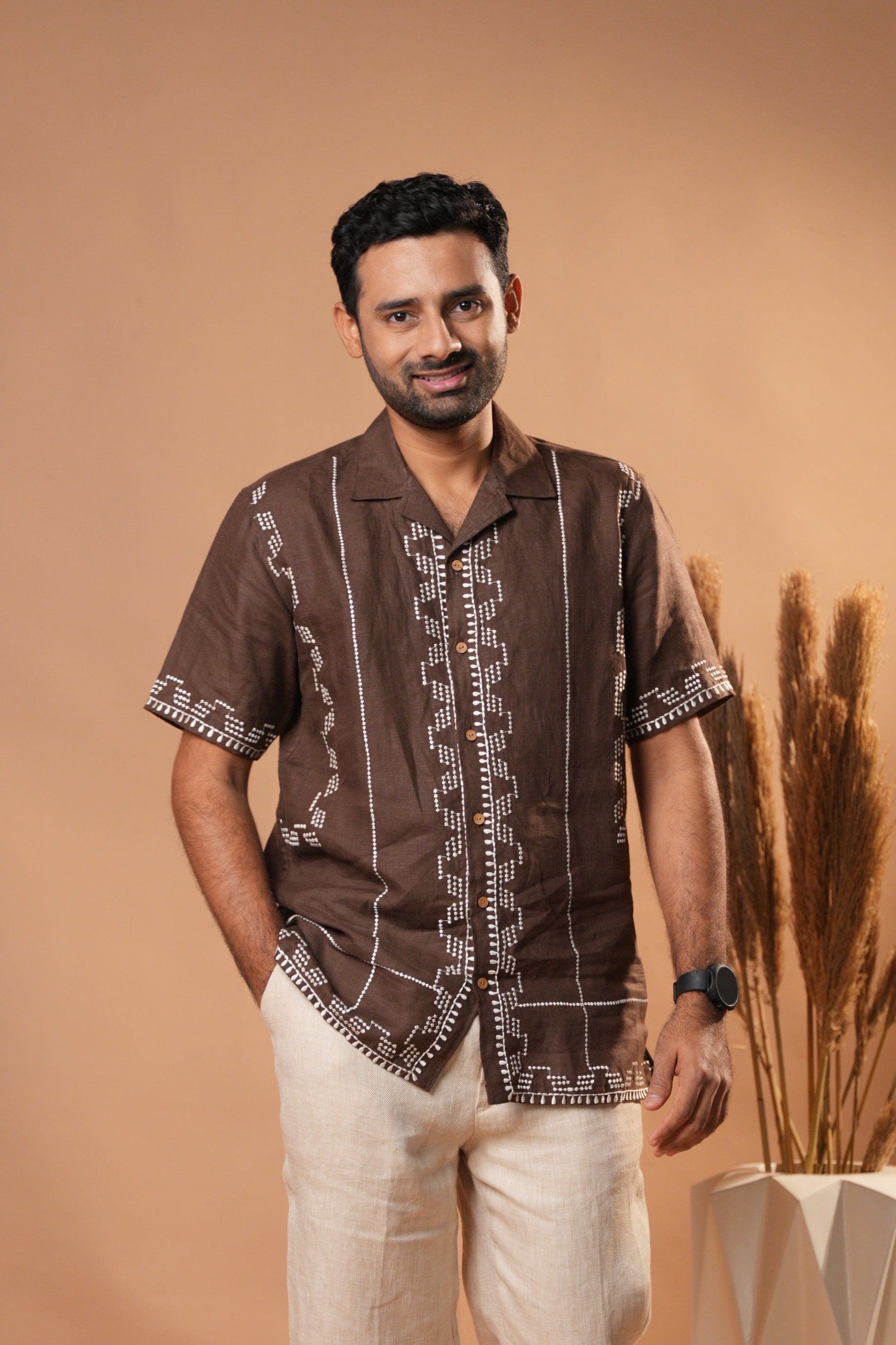 Casual embroidered shirt in rich brown, featuring intricate stitching for a sophisticated look.