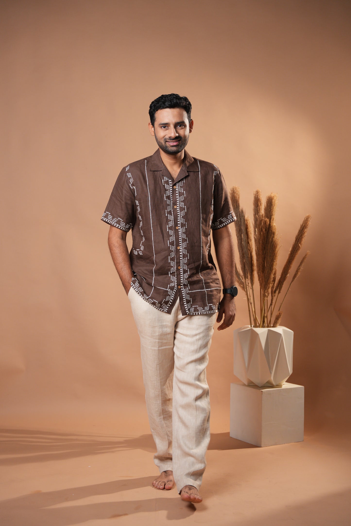 Men’s rich brown embroidered shirt, showcasing unique threadwork on the cuffs and collar.