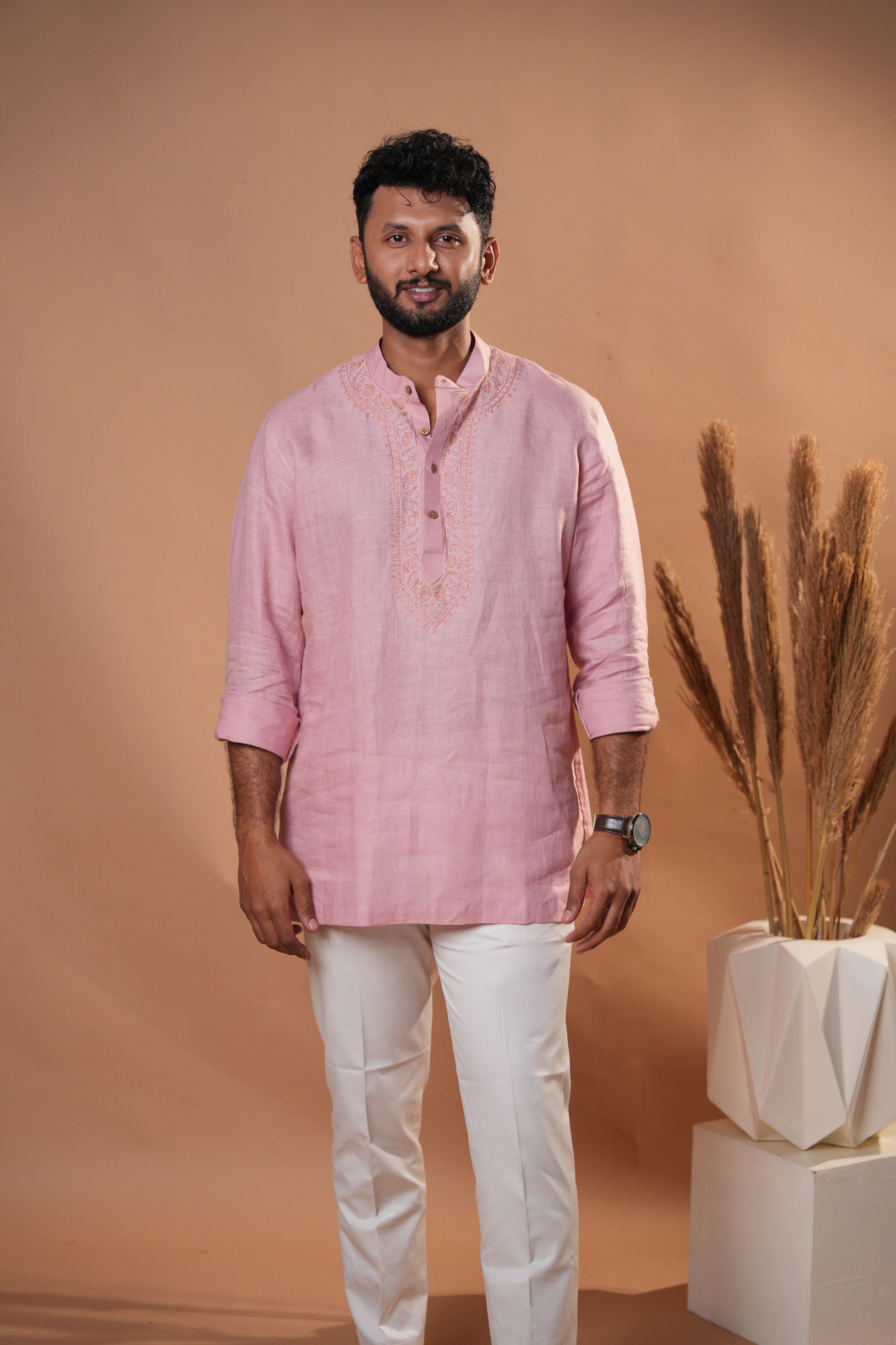 Elegant soft pink short kurta featuring traditional Chikankari embroidery for a graceful look.