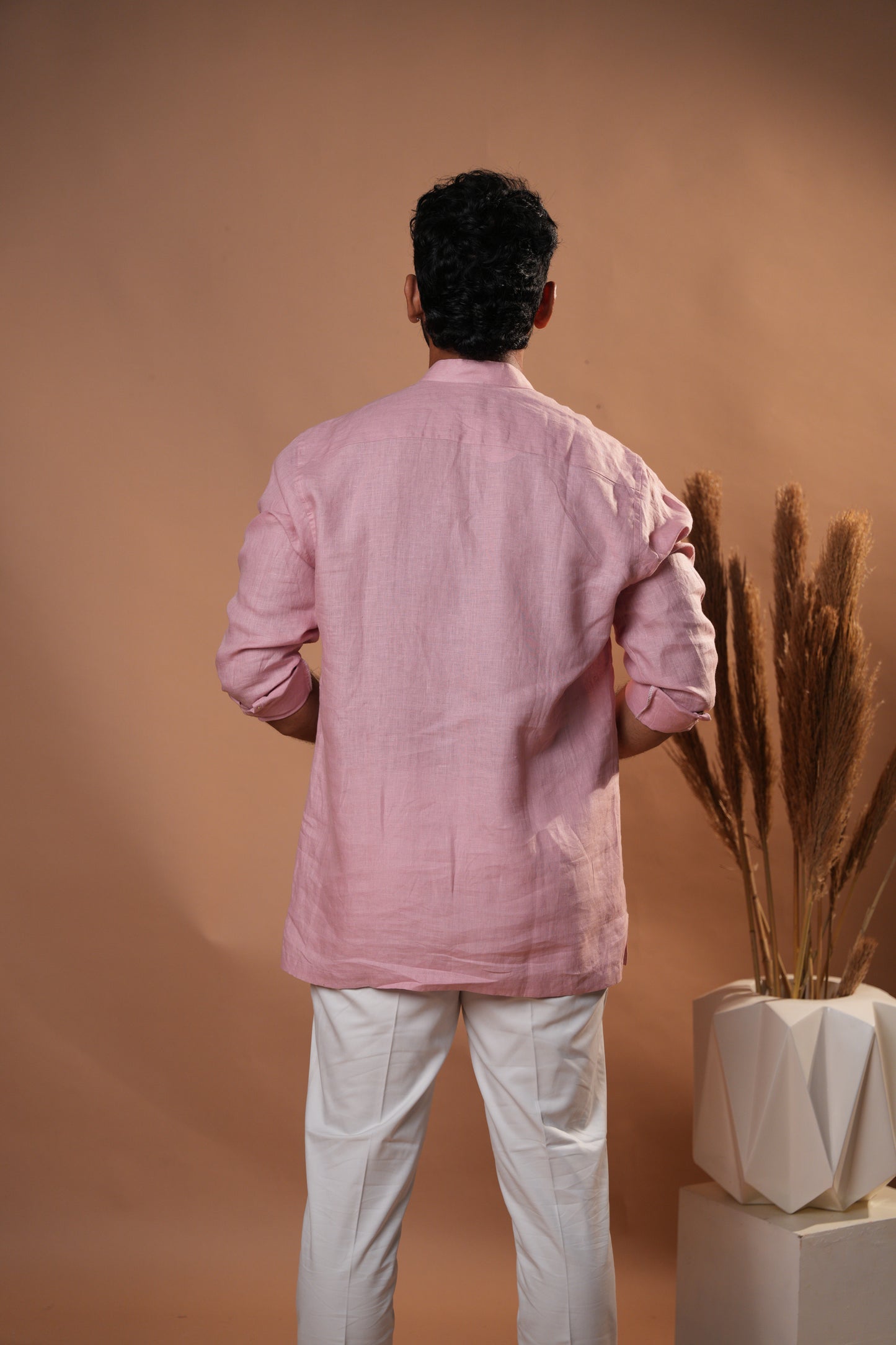 Close-up of a soft pink short kurta, highlighting fine Chikankari embroidery and a comfortable fit.