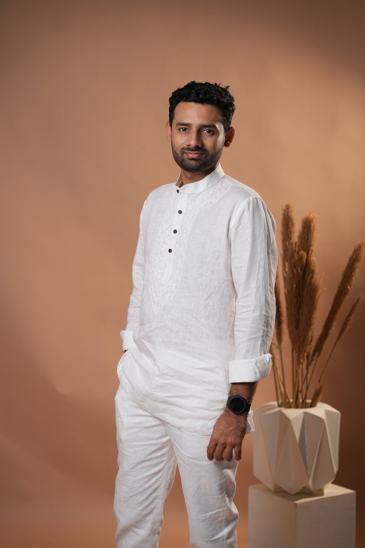 Elegant pure white short kurta with Chikankari detailing, perfect for festive and casual occasions.