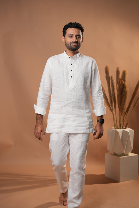 Pure white Chikankari short kurta, featuring intricate hand-embroidered floral patterns.