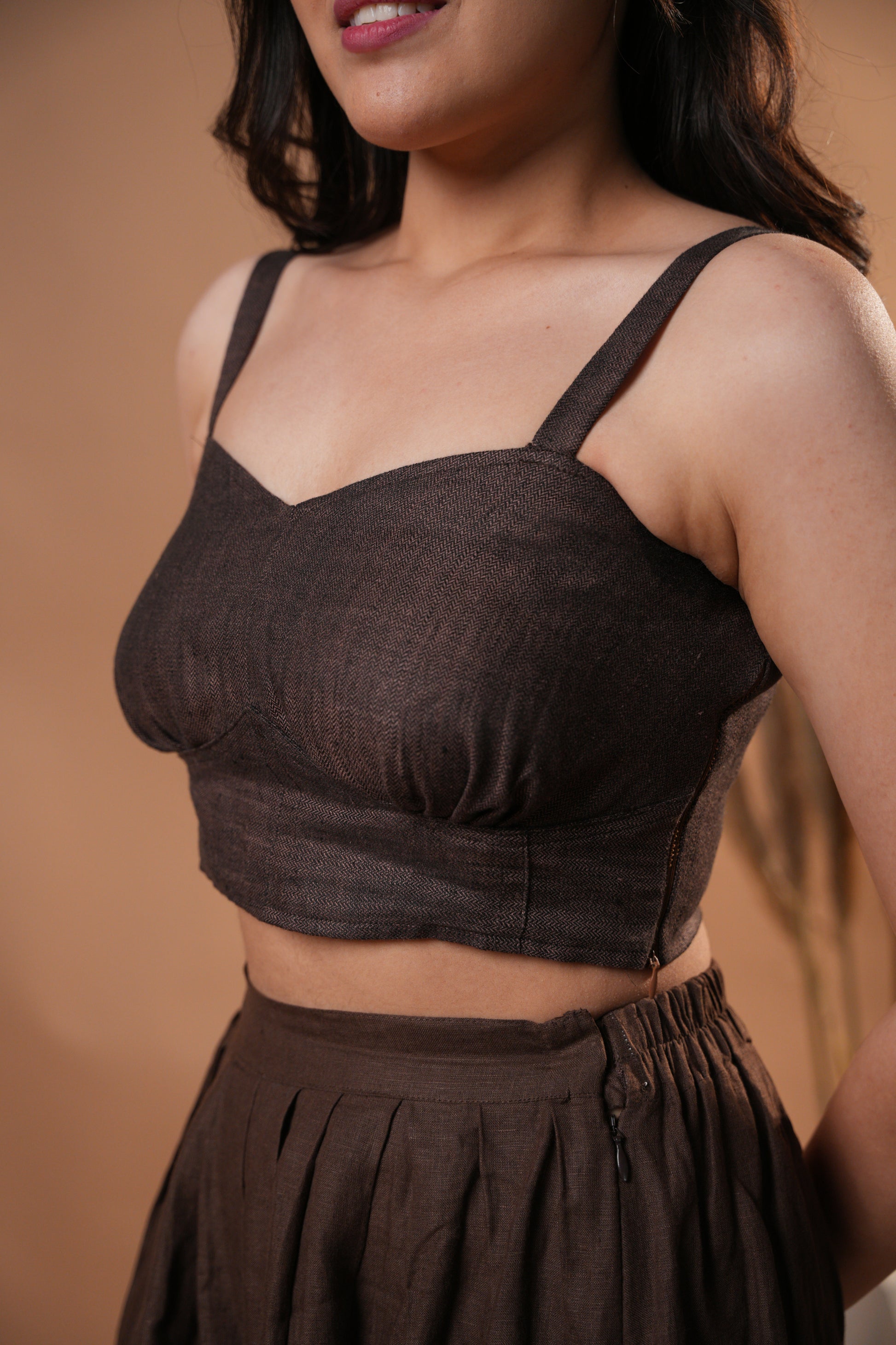 Elegant herringbone corset top with a structured fit and intricate pattern, perfect for a chic, tailored look.